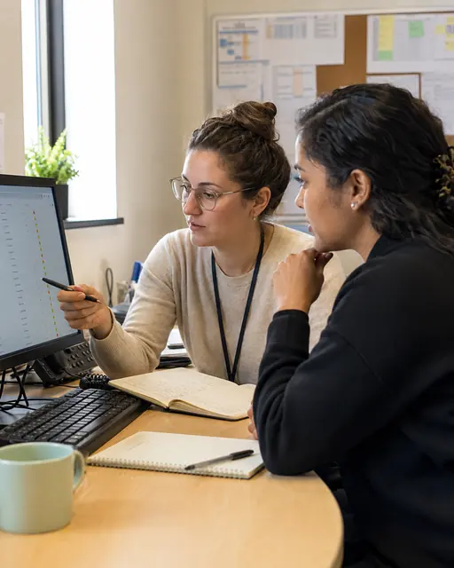 Research enrollment professionals reviewing participant outreach and referral information.